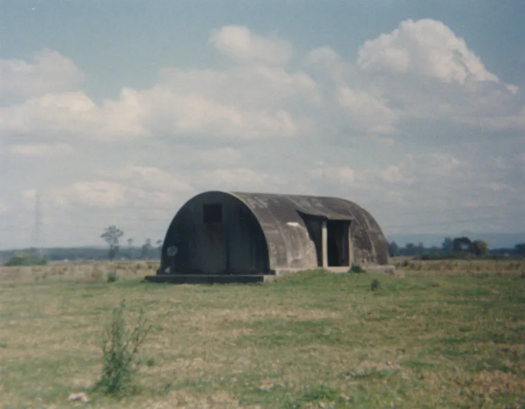 The igloo standing alone on mown grass under a big sky