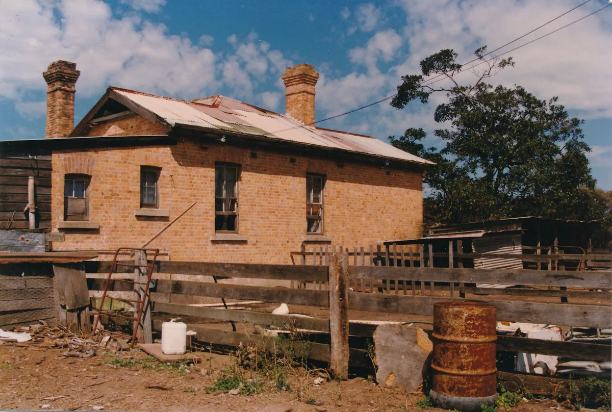 The timber skillion wing with brick chimney, clothesline and hanging buckets