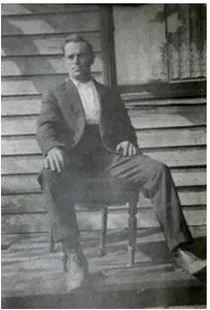 Scanned photograph of Thomas Peterson seated on a chair against a weatherboard wall